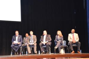 Board and Dr. Nichols seated on stage